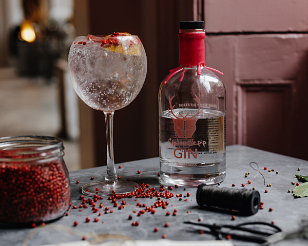 Shnoodlepip Gin garnished with red berries