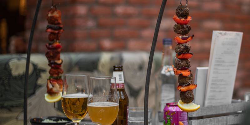the botanist hanging kebabs served with sweet potato fries and a bottle of peroni